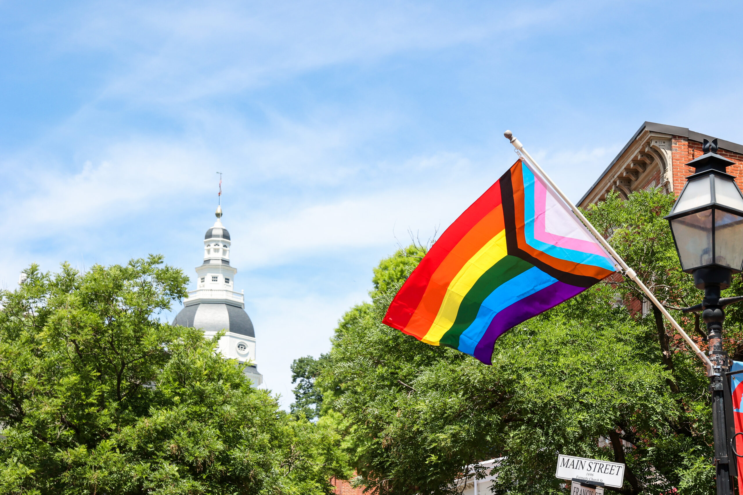 Pride flag flying with Annapolis in background
